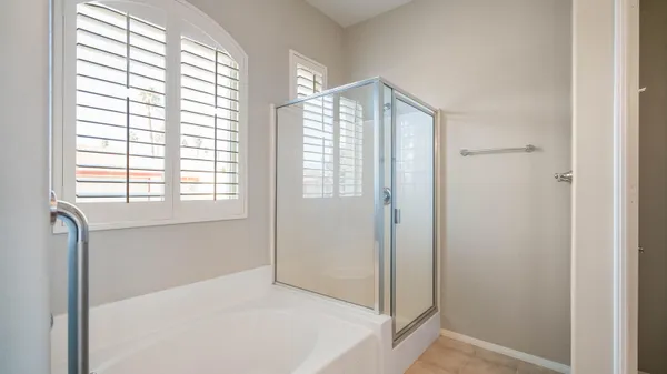 a bedroom with a bed and a mirror