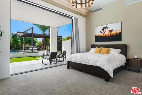 a bedroom with a bed and wall painting