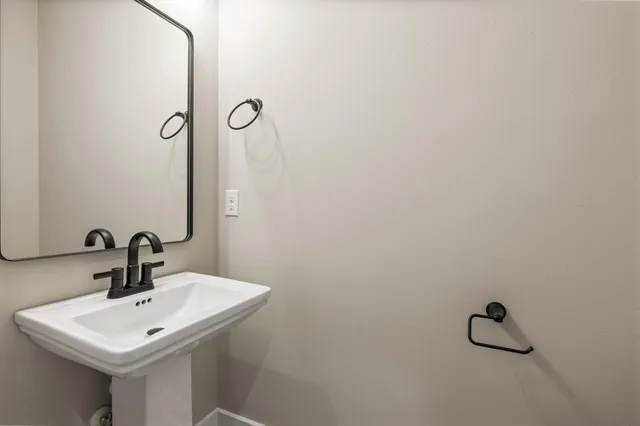 a bathroom with a sink and mirror