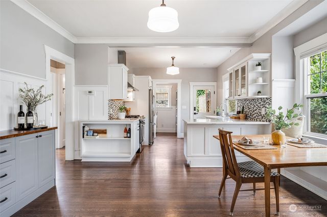 a kitchen with counter top space and living room