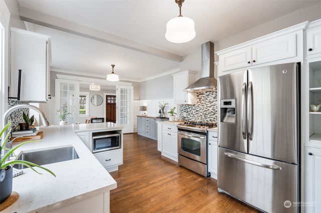 a kitchen with a stove top oven and refrigerator