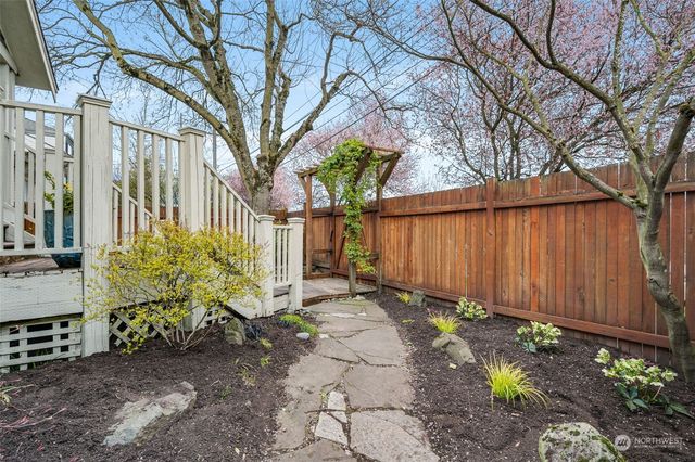 a view of a chair and table in backyard