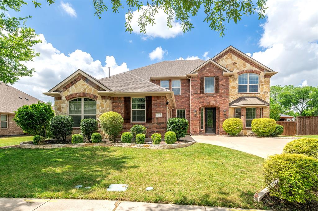 12571 Valley Spring Drive Frisco, TX 75035 - Photo 1 of 39 a front view of a house with a yard and garage