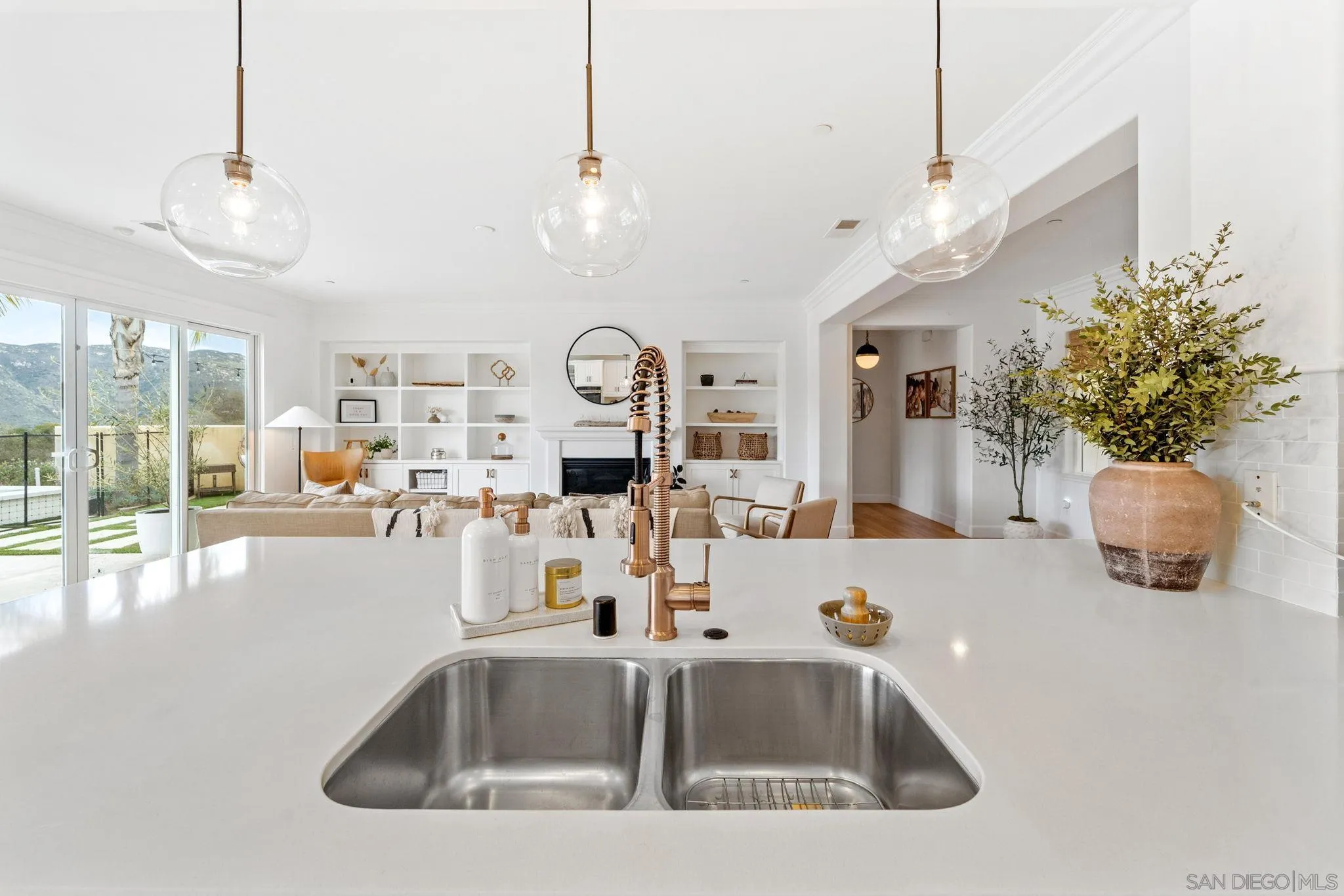 2836 Mesa Grove Road Fallbrook, CA 92028 - Photo 16 of 46 a kitchen with a sink a counter and a view of living room
