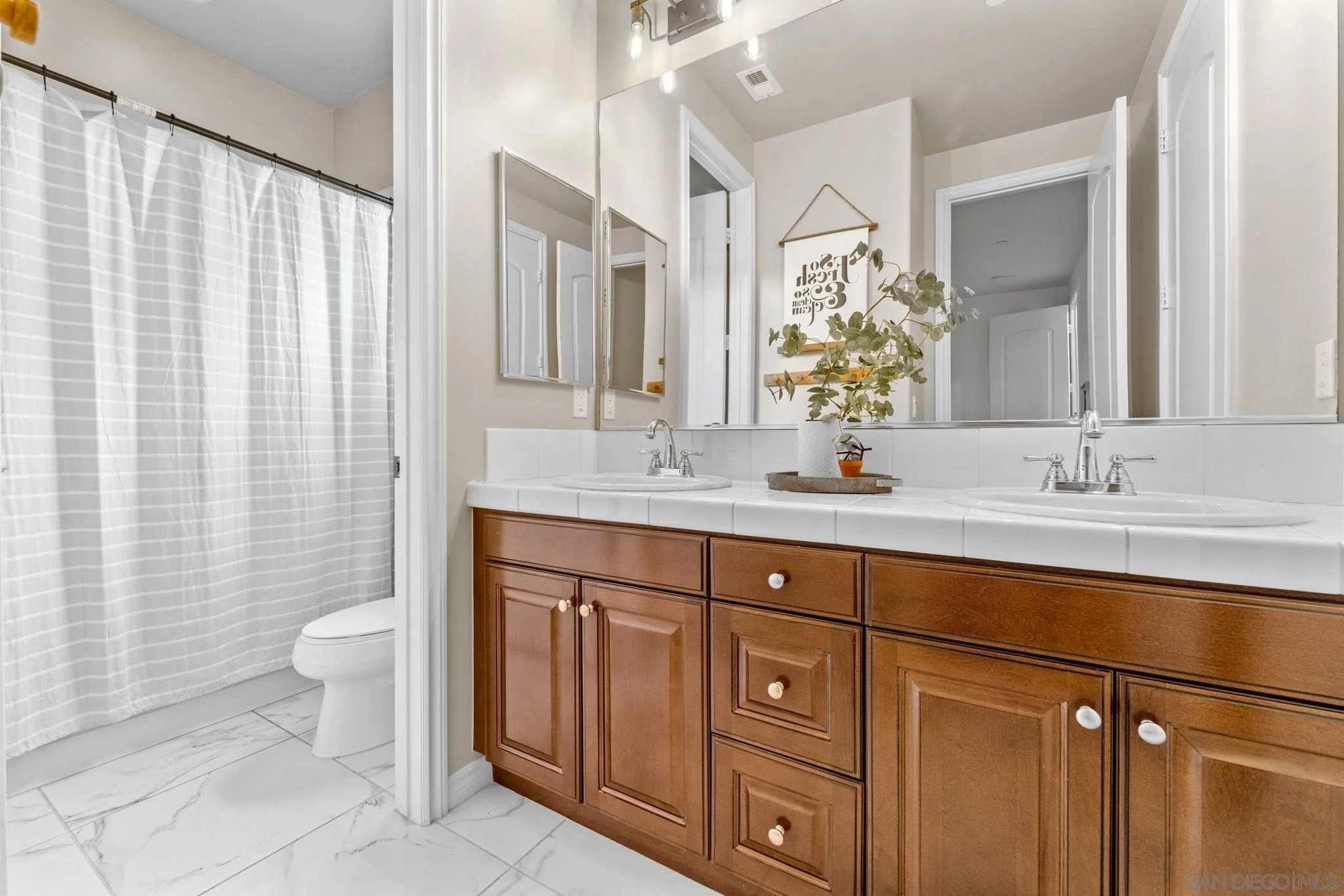 2836 Mesa Grove Road Fallbrook, CA 92028 - Photo 39 of 46 a bathroom with a double vanity sink and a mirror