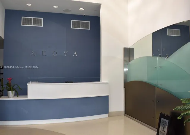 a view of a patio with dining table and chairs with floor to ceiling window