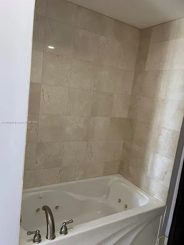 a bathroom with a shower sink mirror and toilet
