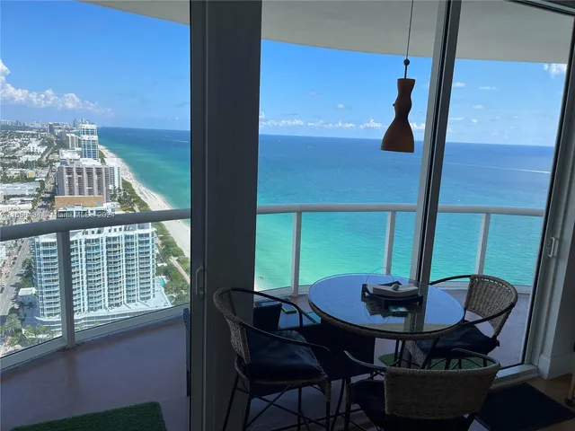 a kitchen with stainless steel appliances granite countertop a refrigerator and a stove