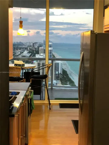 a kitchen with stainless steel appliances kitchen island granite countertop a refrigerator and a stove top oven