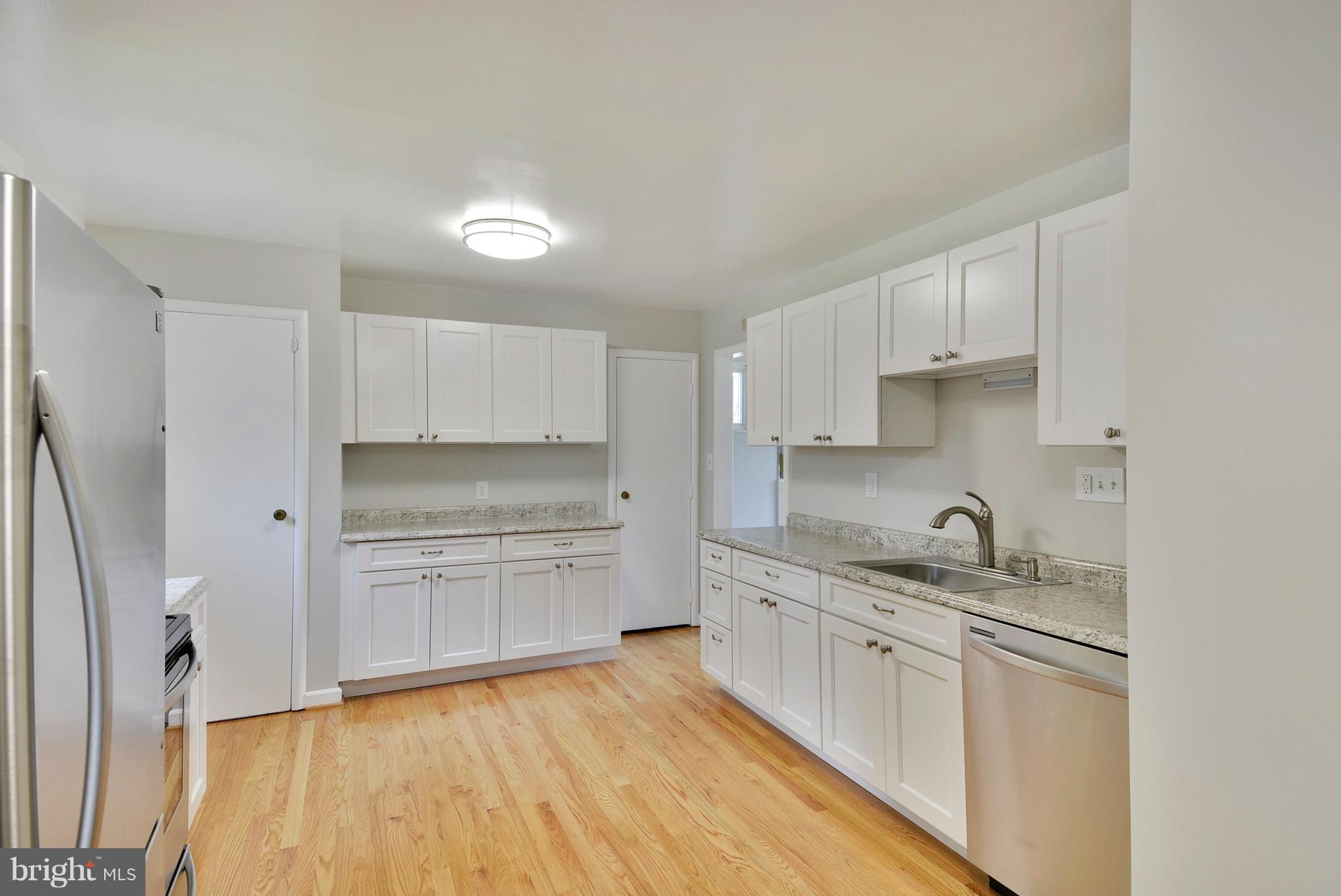 12719 Feldon Street Silver Spring, MD 20906 - Photo 6 of 30 a kitchen with a sink a stove and cabinets