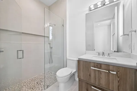 a bathroom with a sink toilet and shower