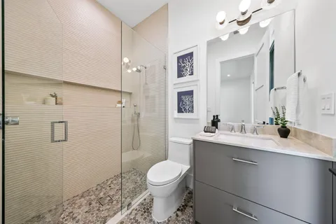 a bathroom with a sink toilet and shower