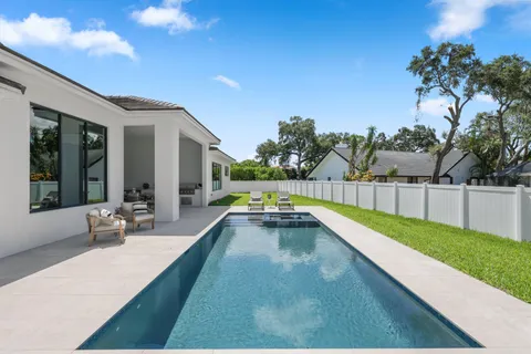 a view of a house with pool table and chairs