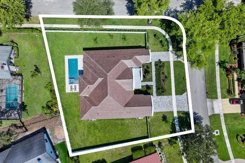 an aerial view of residential houses with outdoor space and swimming pool