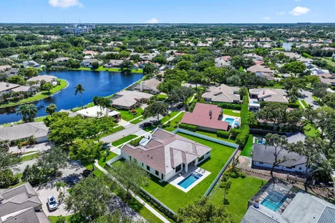an aerial view of residential houses with outdoor space and lake view