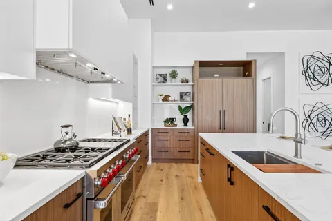 a kitchen that has a sink and a stove