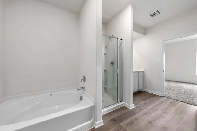 a bathroom with a bathtub and a shower