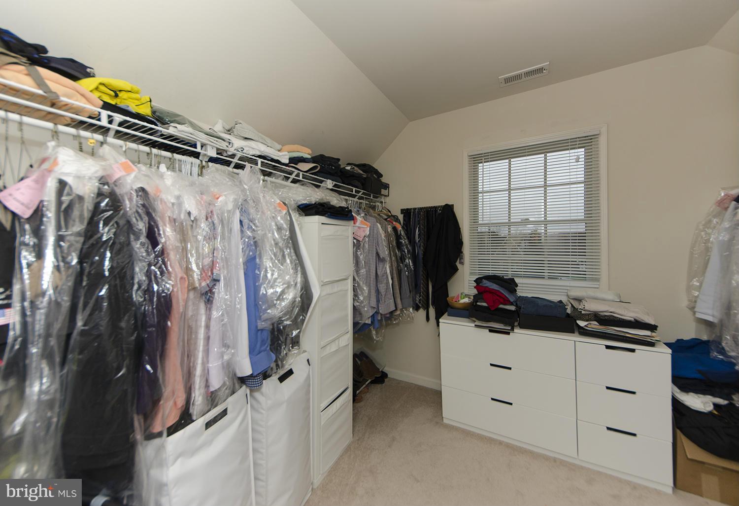 10871 Hunter Gate Way Reston, VA 20194 - Photo 11 of 30 a view of walk in closet with clothes and shoes
