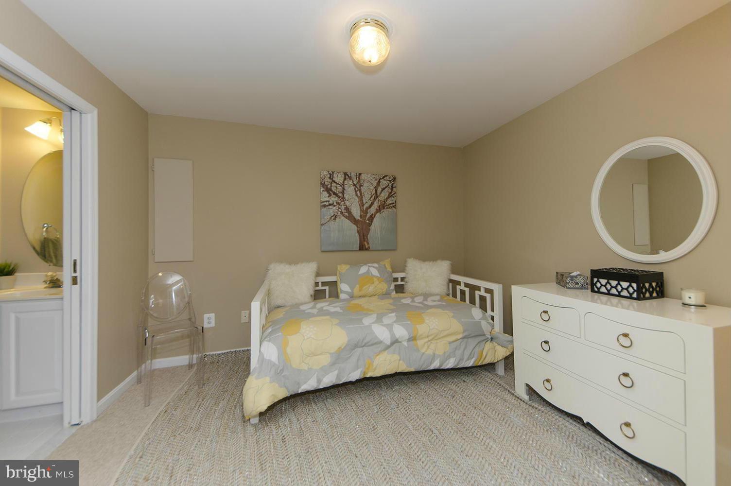 10871 Hunter Gate Way Reston, VA 20194 - Photo 12 of 30 a spacious bedroom with a bed and a table in it
