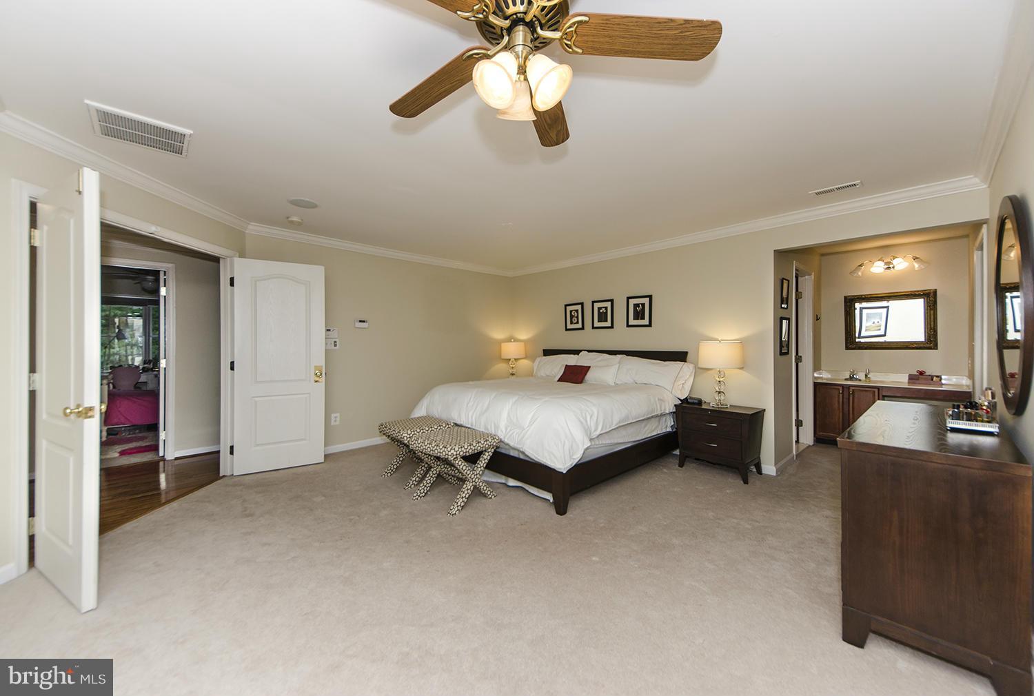 10871 Hunter Gate Way Reston, VA 20194 - Photo 15 of 30 a bedroom with a bed and a chandelier