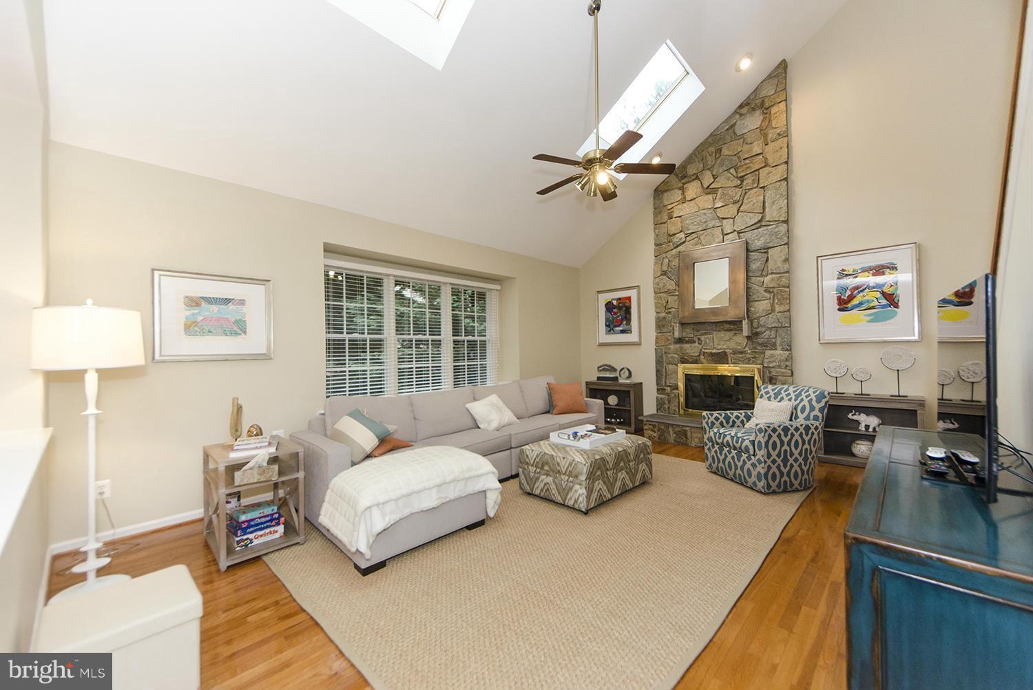 10871 Hunter Gate Way Reston, VA 20194 - Photo 3 of 30 a living room with furniture fireplace and a flat screen tv