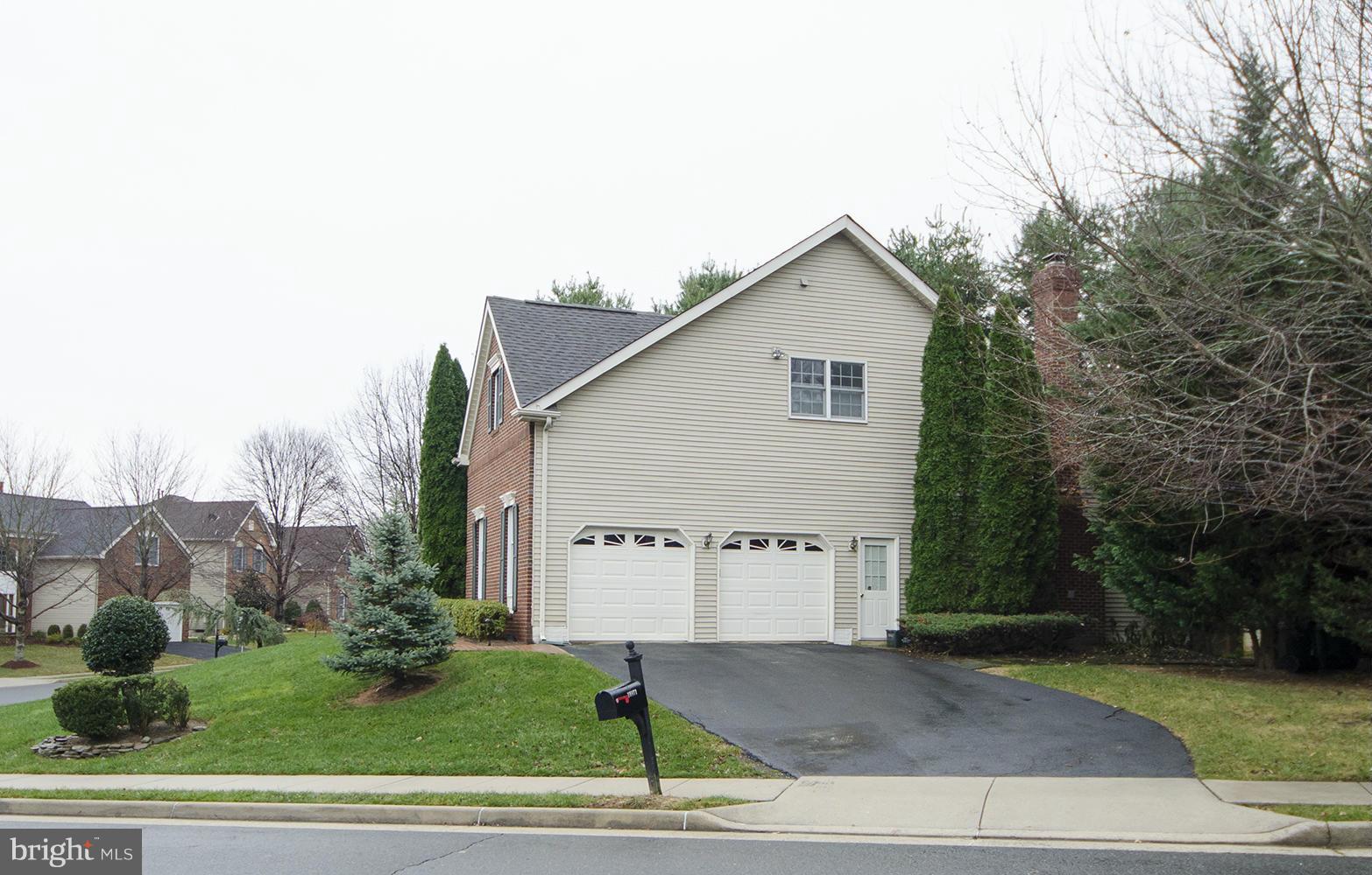 10871 Hunter Gate Way Reston, VA 20194 - Photo 30 of 30 a view of a house with a yard and garage