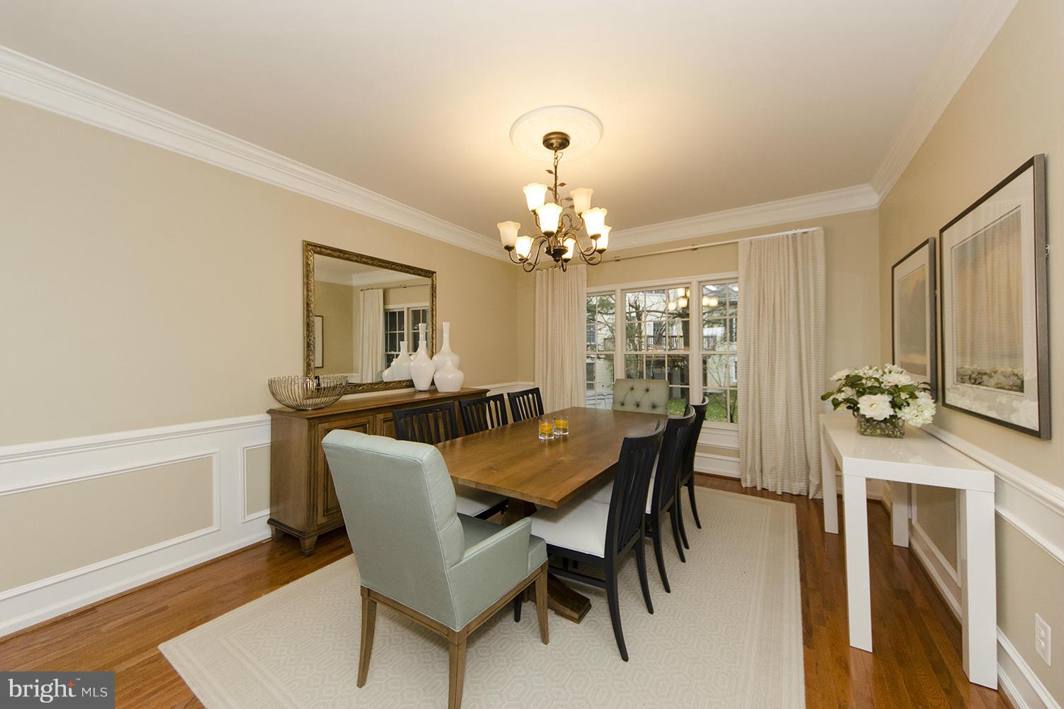 10871 Hunter Gate Way Reston, VA 20194 - Photo 4 of 30 a view of a dining room with furniture and a chandelier