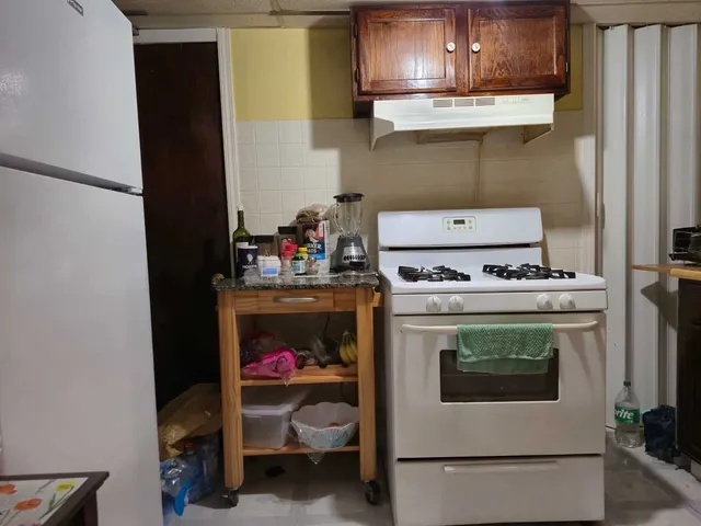 a kitchen with a stove and cabinets