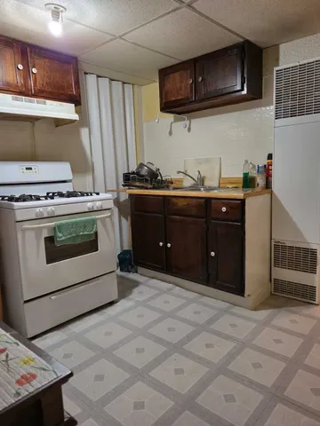 a kitchen with stainless steel appliances granite countertop a stove and a refrigerator