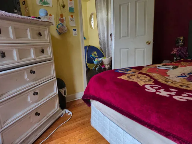 a bed room with a bed and a dresser