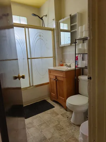 a bathroom with a toilet a sink and a shower