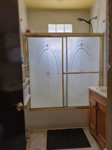 a view of a room that has a couch and wooden floor