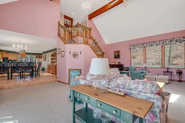 a view of a livingroom with furniture and stairs