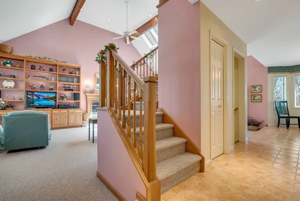 a dining hall with stainless steel appliances granite countertop a stove and a dining table