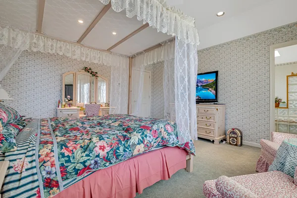 a bedroom with a bed and a mirror