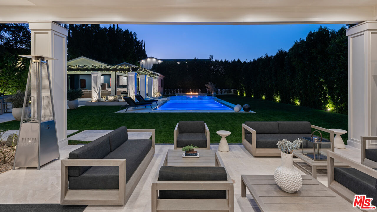 4421 Haskell Avenue Encino, CA 91436 - Photo 12 of 40 a view of a patio with couches table and chairs with potted plants and big yard
