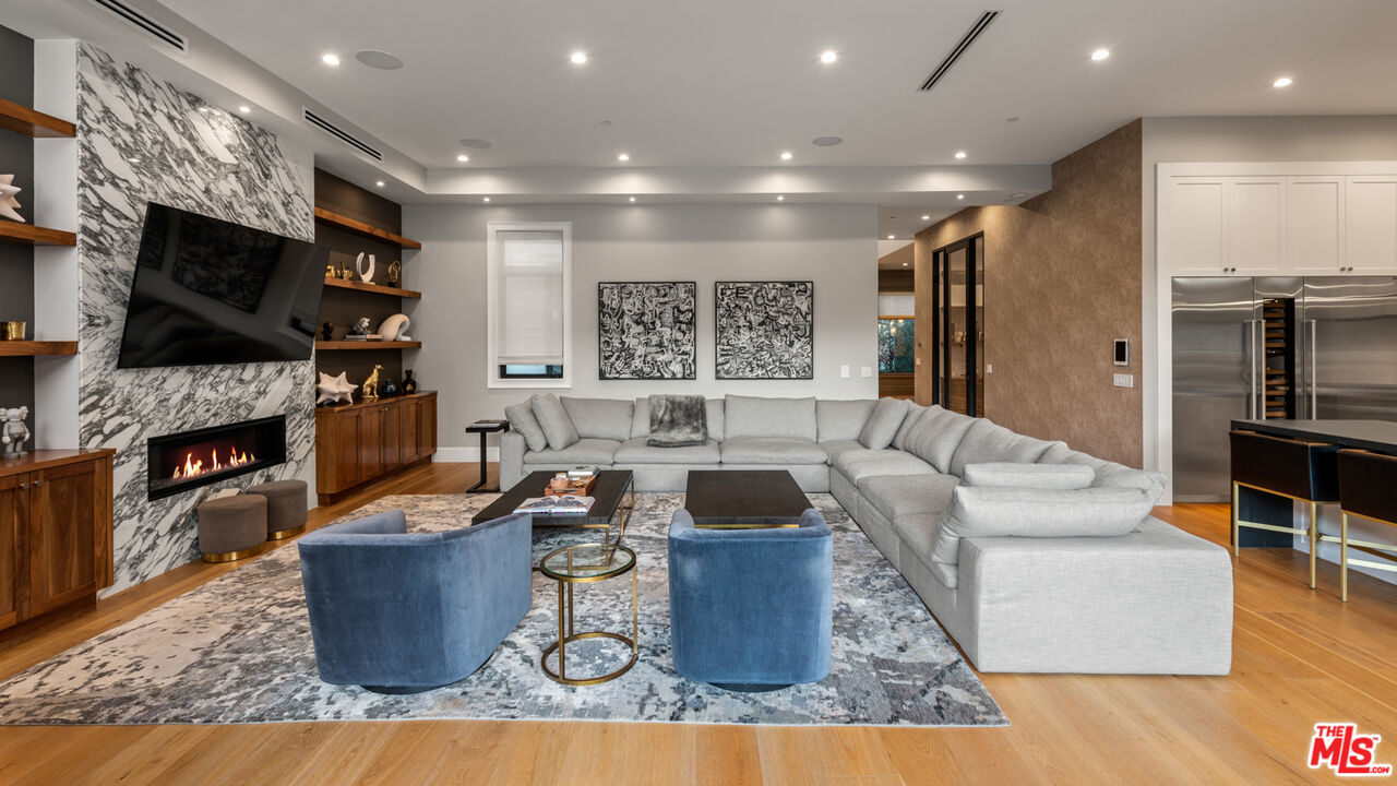 4421 Haskell Avenue Encino, CA 91436 - Photo 13 of 40 a living room with fireplace furniture and a flat screen tv