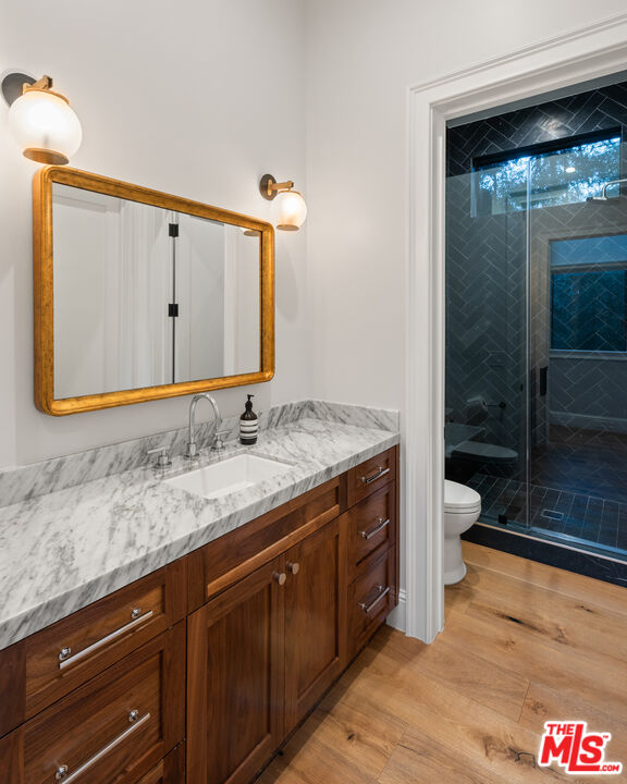 4421 Haskell Avenue Encino, CA 91436 - Photo 21 of 40 a bathroom with a granite countertop sink and a mirror