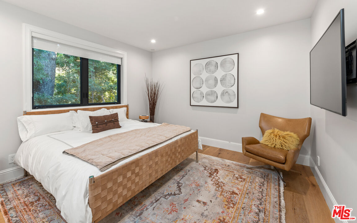 4421 Haskell Avenue Encino, CA 91436 - Photo 29 of 40 a bedroom with a large bed and a large window