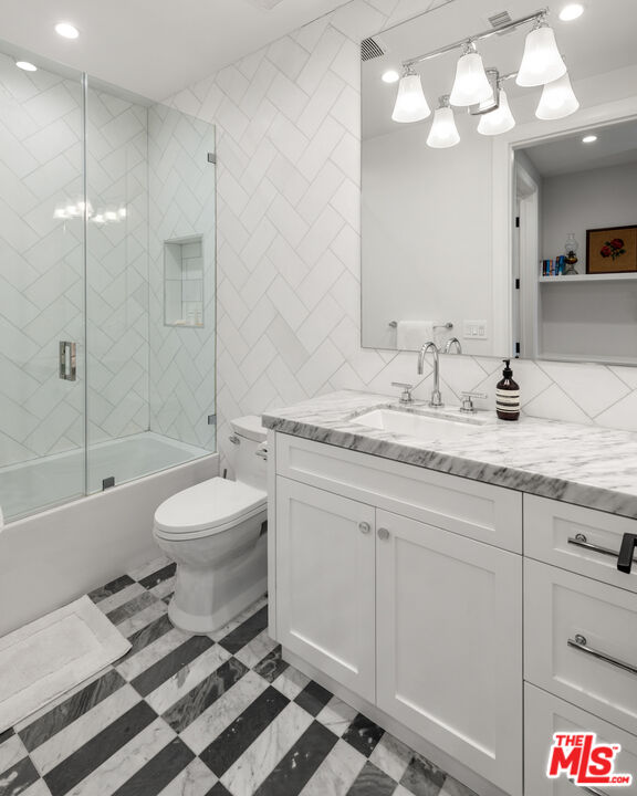 4421 Haskell Avenue Encino, CA 91436 - Photo 32 of 40 a bathroom with a sink a toilet and a bathtub