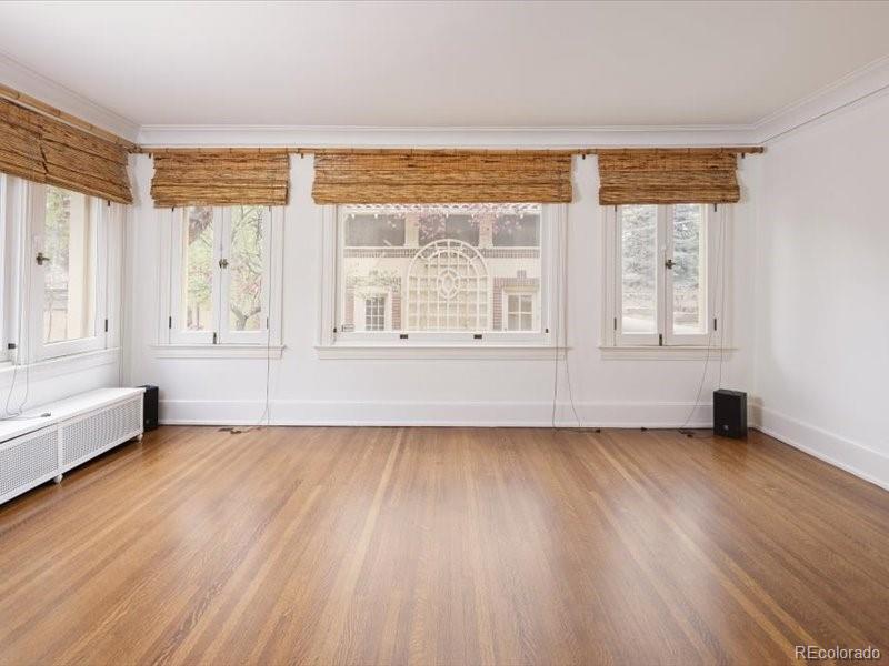 199 Lafayette Street Denver, CO 80218 - Photo 15 of 49 a view of an empty room with wooden floor and a window