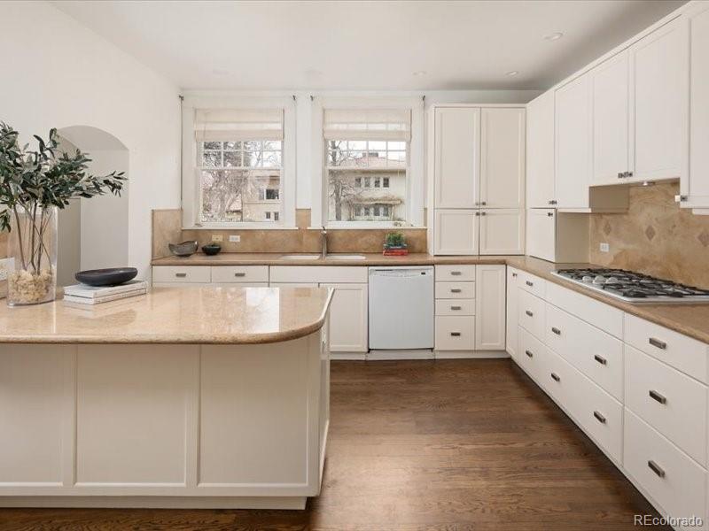 199 Lafayette Street Denver, CO 80218 - Photo 18 of 49 a kitchen with stainless steel appliances granite countertop a sink and cabinets