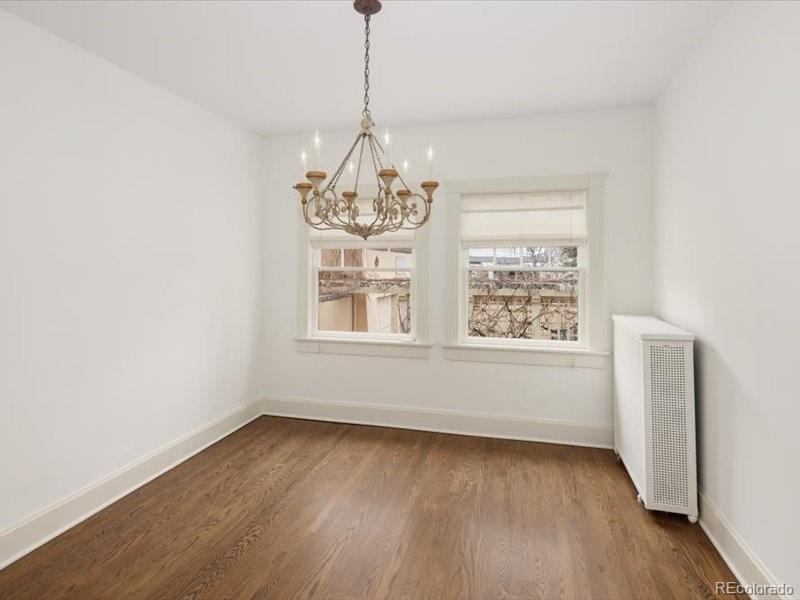 199 Lafayette Street Denver, CO 80218 - Photo 28 of 49 a view of an empty room with wooden floor and a window
