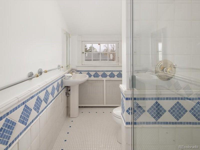 199 Lafayette Street Denver, CO 80218 - Photo 35 of 49 a bathroom with a sink and mirror with bathtub