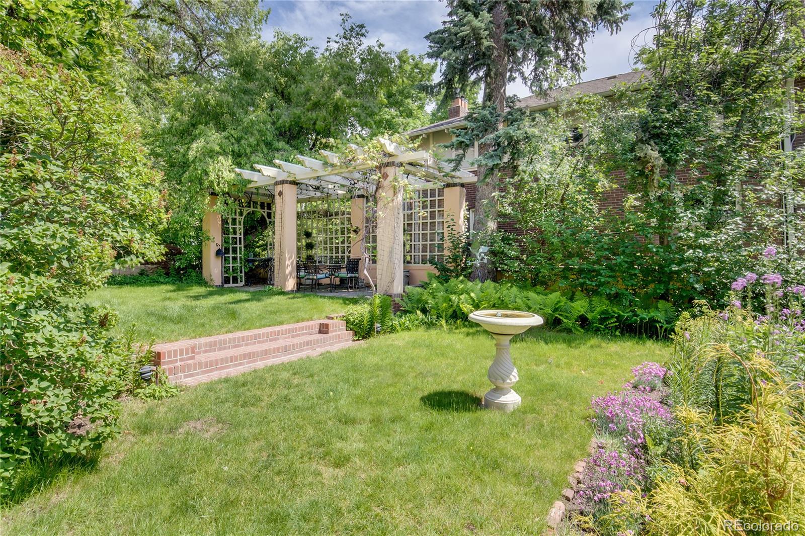 199 Lafayette Street Denver, CO 80218 - Photo 44 of 49 a view of a fountain with plants and large trees