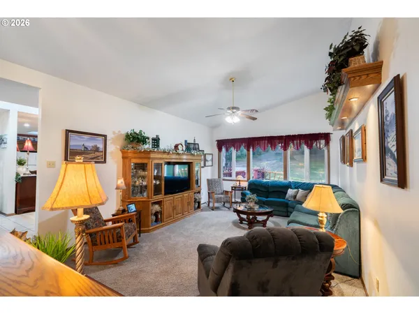 a living room with furniture flat screen tv and a fireplace