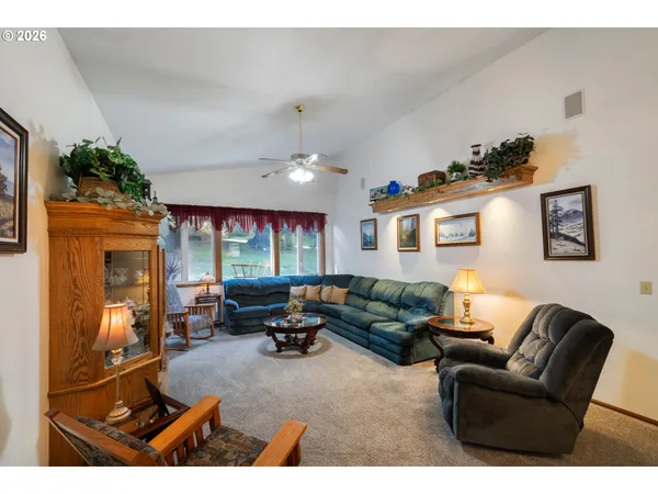 a living room with furniture gym equipment and a large window