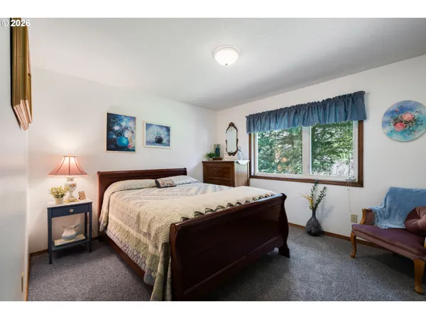 a bedroom with a bed window and couch