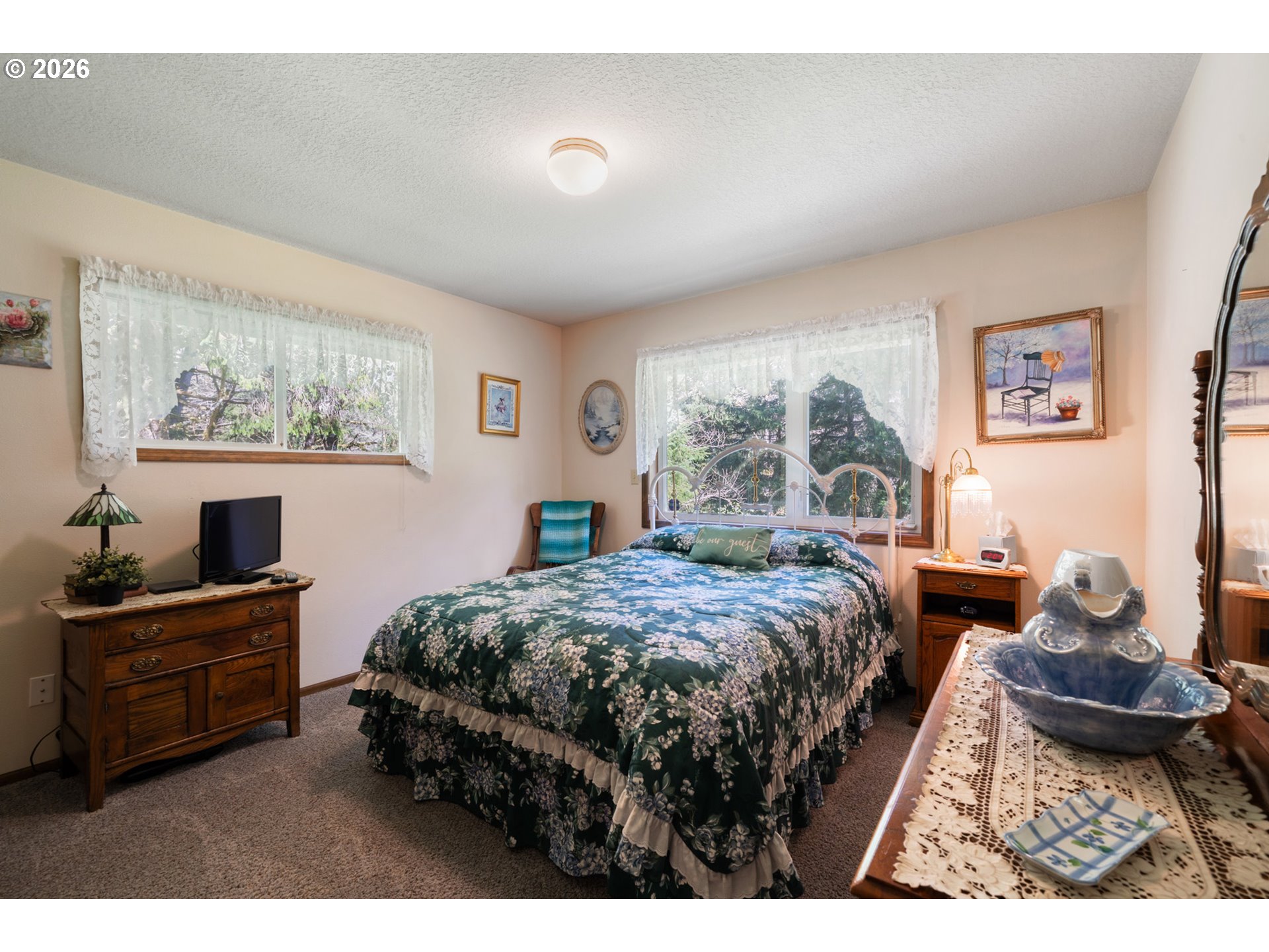 23100 Miami Foley Road Nehalem, OR 97131 - Photo 29 of 47 a bedroom with a bed and large windows