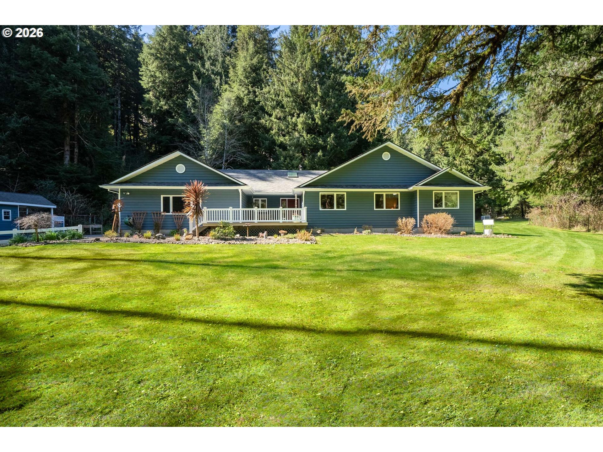 23100 Miami Foley Road Nehalem, OR 97131 - Photo 3 of 47 a front view of a house with a yard table and chairs